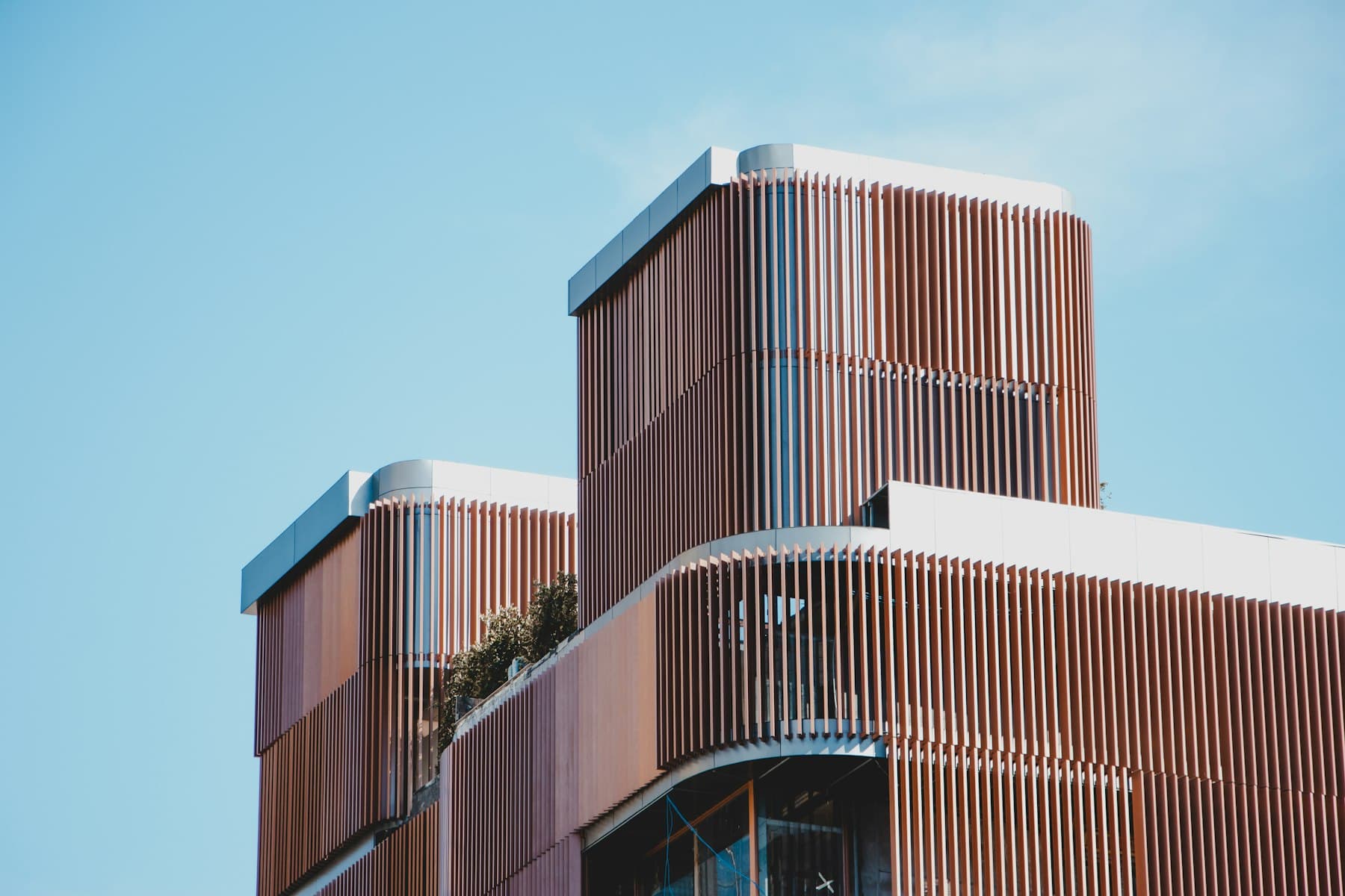 Warm timber-toned commercial façade against a clear sky